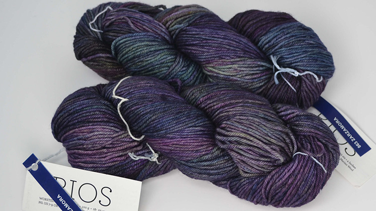 A photograph of two skeins of Malabrigo Rios purple yarn.